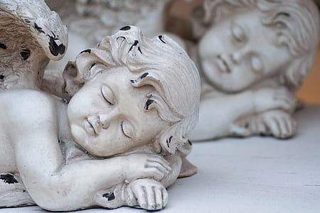 white angel figurines on white surface thumbnail