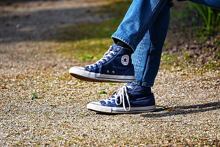 person wearing blue Converse shoes thumbnail