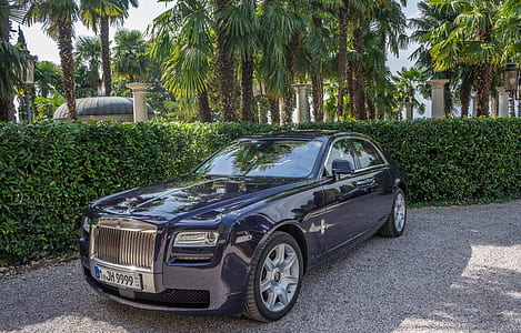 blue Rolls Royce Phantom near bushes during daytime thumbnail
