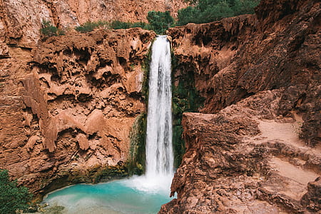 waterfalls surrounded by cliff thumbnail