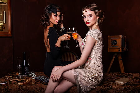 two women toasting using wine glass together thumbnail