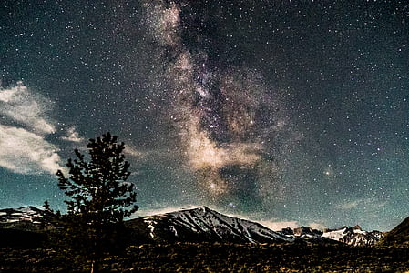 snow-covered mountain under starry sky thumbnail