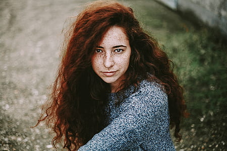 focus photography of woman sitting on forest trail thumbnail
