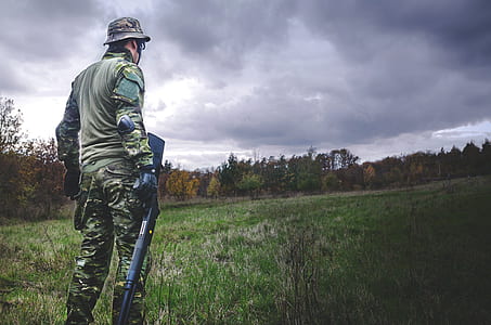 Man in Camouflage Soldier Suit While Holding Black Hunting Rifle thumbnail