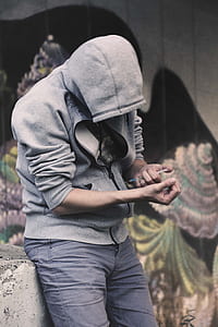 person holding injection wearing gray zip-up hoodie during daytime thumbnail