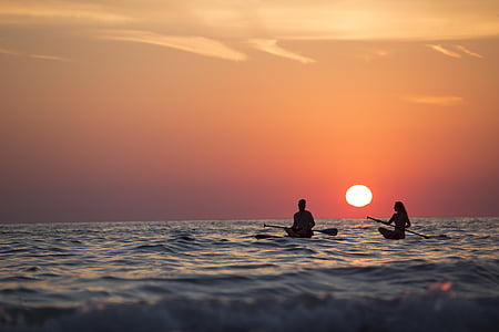 man and woman paddling in the middle of the sea thumbnail