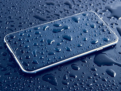silver iPhone X filled with water droplets on black surface thumbnail