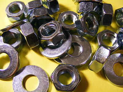 metal hex nut on yellow surface thumbnail