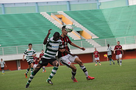 two male soccer players chasing soccer ball thumbnail