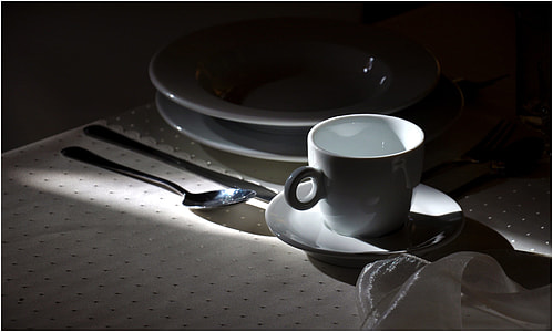 white ceramic cup and saucer on table thumbnail