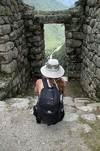 woman sitting on concrete stairs on temple during daytime thumbnail