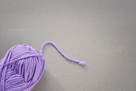 rolled purple yarn on gray surface thumbnail