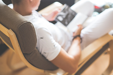 Man Reading a Book in a Chair thumbnail