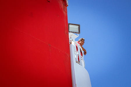 man standing on white balcony thumbnail