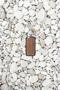 flat-lay photography of silver iPhone 6 and brown case thumbnail
