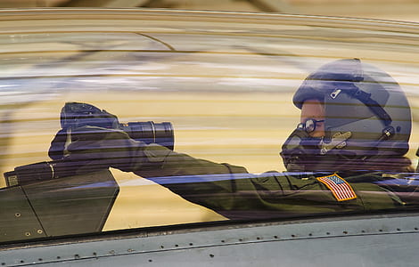 pilot holding DSLR camera while inside jet plabne thumbnail
