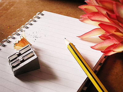 photo of pencil and grey sharpener on notebook thumbnail