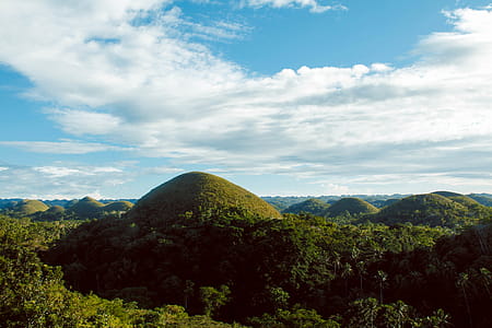 Scenic View of Hills Surrounded By Trees thumbnail