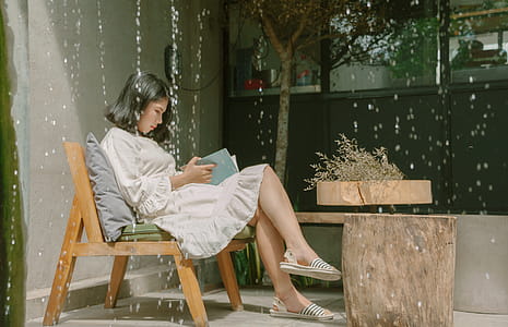 Woman Sitting While Reading a Book thumbnail