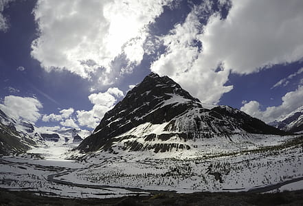 landscape photography of snowy mountain under cloudy sky thumbnail