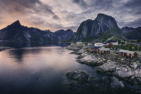photography of mountains beside town during cloudy sky thumbnail