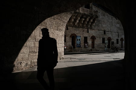 silhouette photo of man standing on tunnel thumbnail