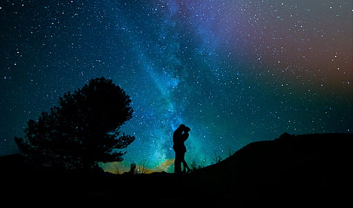 silhouette couple kissing under starry night thumbnail