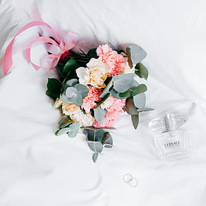 bouquet of flowers beside Versace bottle thumbnail