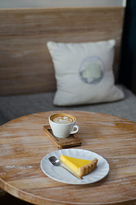 white ceramic coffee mug on round brown wooden table thumbnail