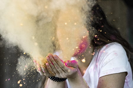 Woman in White Cap-sleeved Shirt Blowing Dust thumbnail