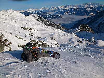 person sliding on snowy mountain with snowboard on his feet thumbnail