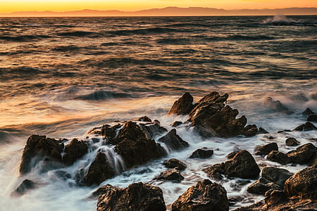 body wave of water hitting rocks thumbnail