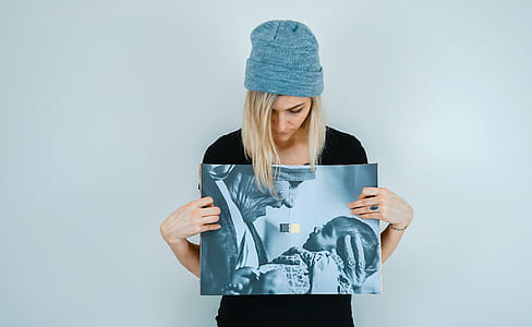 woman holding photo of sister holding up baby thumbnail