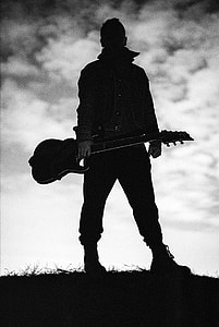 man holding  electric guitar silhouette thumbnail
