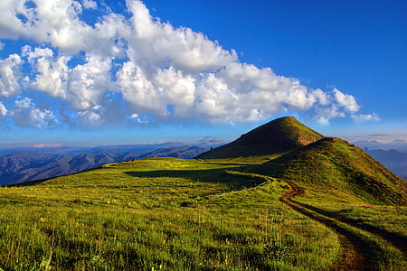 hills with green grass field during daytime thumbnail