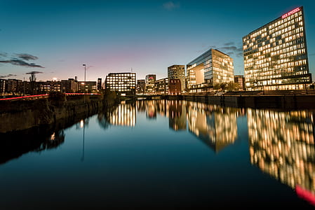 reflective photography of concrete buildings during daytime thumbnail