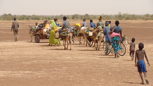 march of people on desert thumbnail