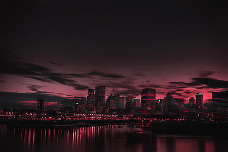 photo of lighted city buildings with bloody sky at nighttime thumbnail