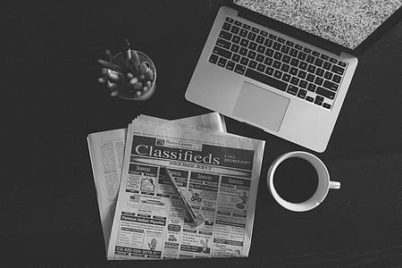 grayscale photo of laptop computer beside white ceramic mug thumbnail