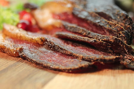 sliced cooked meat on brown wooden board thumbnail
