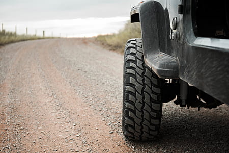 black Jeep Wrangler SUV on road thumbnail
