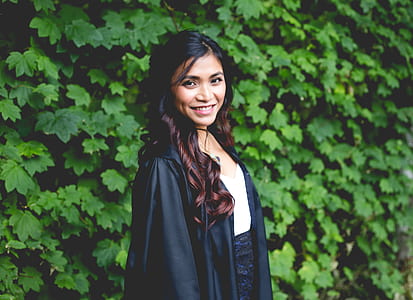 woman wearing black robe against green leafed plants thumbnail