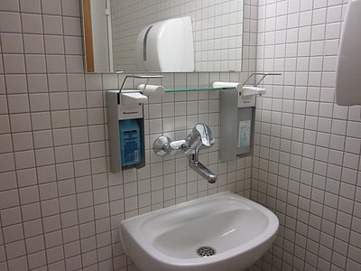 white ceramic bathroom sink and soap dispenser thumbnail