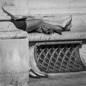 grayscale photography of person sits on stone thumbnail