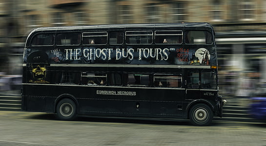 black The Ghost Bus Tours bus on road during daytime thumbnail