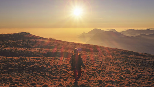woman walking on path of mountain thumbnail