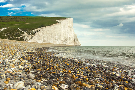 green and white mountain near seashore thumbnail