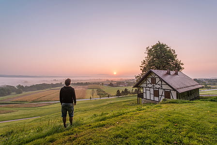 person near house during daytime thumbnail