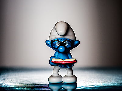 Brainy Smurf figurine on gray surface thumbnail