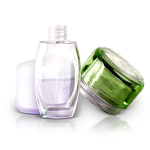 clear glass bottle with two cosmetic jars thumbnail